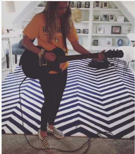 Keeley playing  guitar